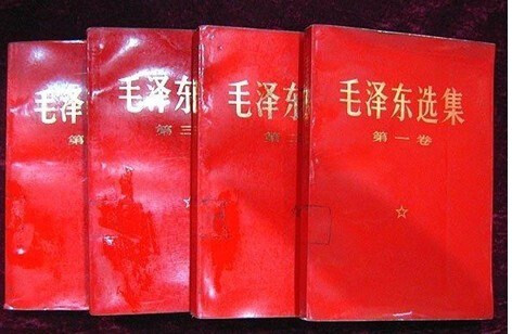 The image shows four volumes of Mao Zedong's Selected Works in Chinese. (Captioned by AI)