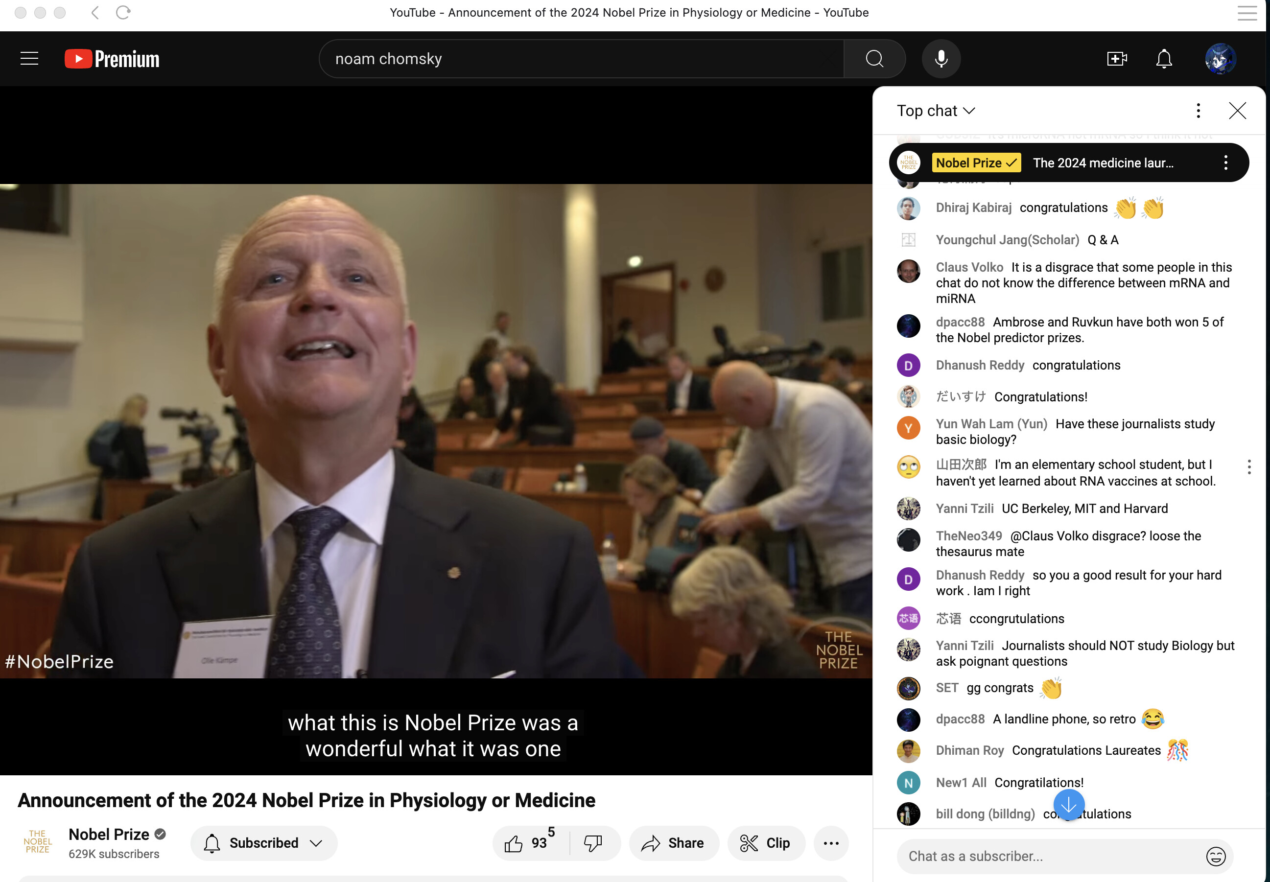 A screenshot shows a YouTube video of the announcement of the 2024 Nobel Prize in Physiology or Medicine, with a man speaking in front of an audience and a live chat discussing the event on the right. (Captioned by AI)