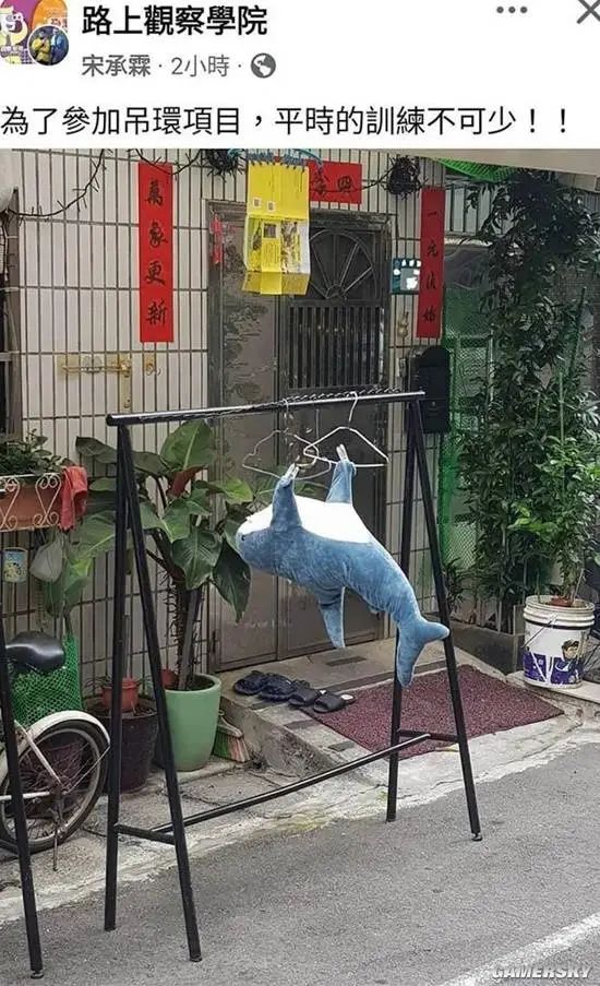 A stuffed shark is hung upside down on a clothes rack outside a home decorated with Chinese New Year decorations. (Captioned by AI)